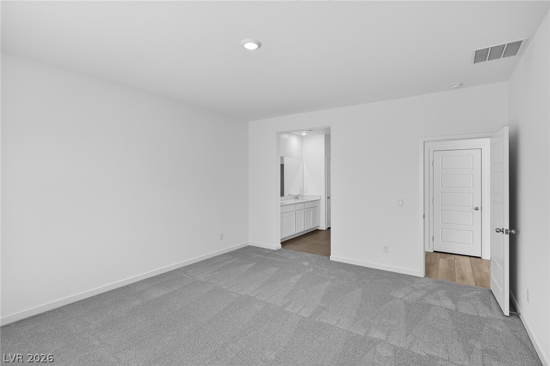 347 Sam Way Mesquite, NV 89027 - Photo 19 of 32 A spacious, naturally illuminated room featuring plush carpeting and convenient access to an adjacent bathroom.