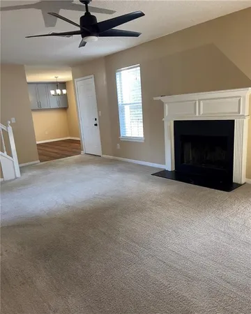 a view of empty room with a fireplace