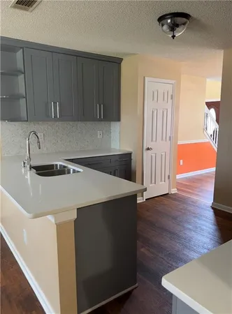 a kitchen with a sink a stove and cabinets