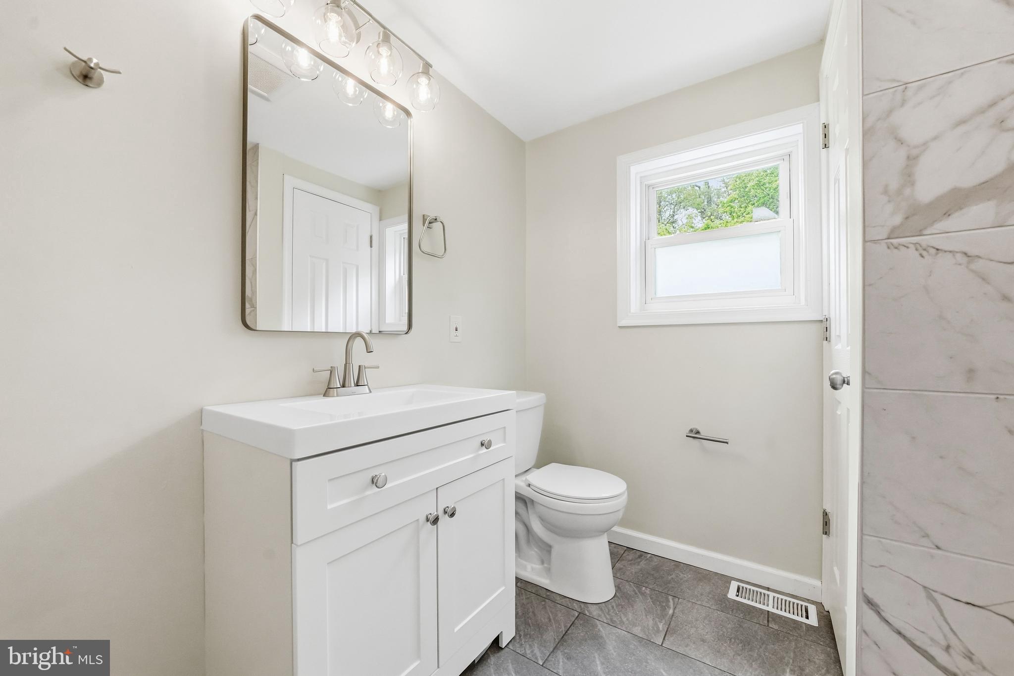 1286 Glassboro Road Williamstown, NJ 08094 - Photo 21 of 41 a bathroom with a sink a toilet and a mirror