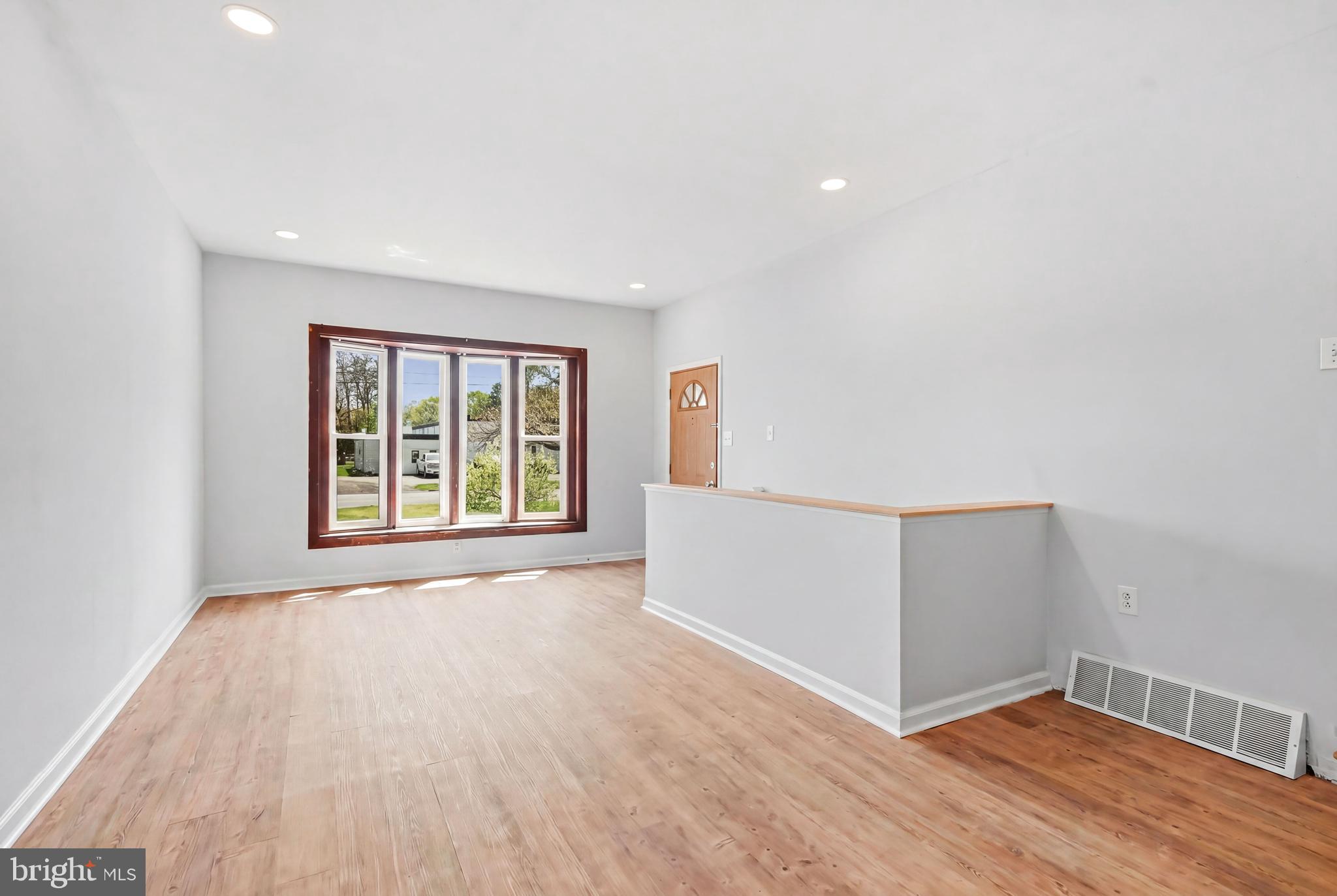 1286 Glassboro Road Williamstown, NJ 08094 - Photo 8 of 41 a view of an empty room with wooden floor and a window
