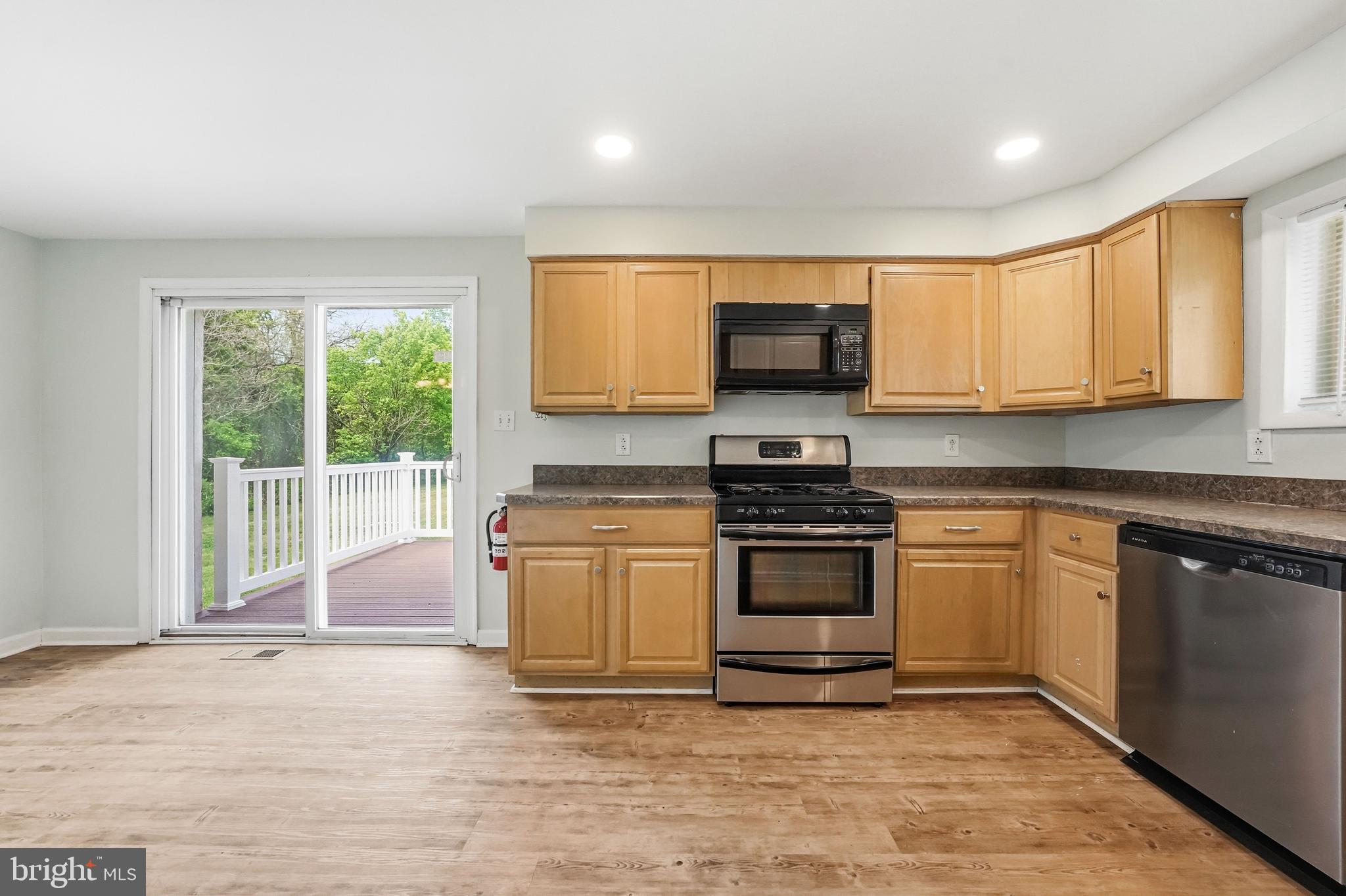 1286 Glassboro Road Williamstown, NJ 08094 - Photo 10 of 41 a kitchen with stainless steel appliances granite countertop a stove a sink and a microwave