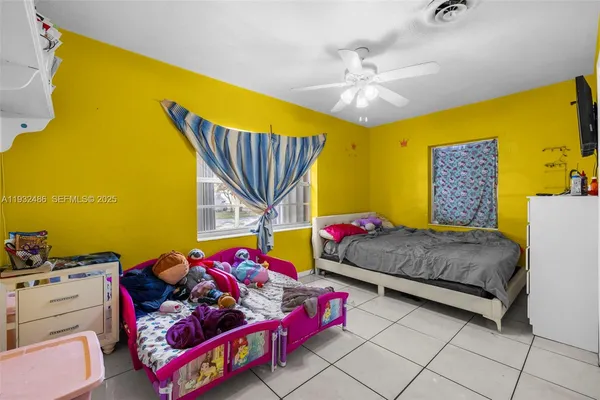 a bedroom with a bed and ceiling fan