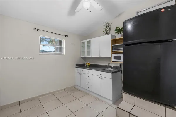 a kitchen with granite countertop cabinets and refrigerator