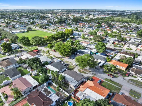 an aerial view of residential houses with outdoor space