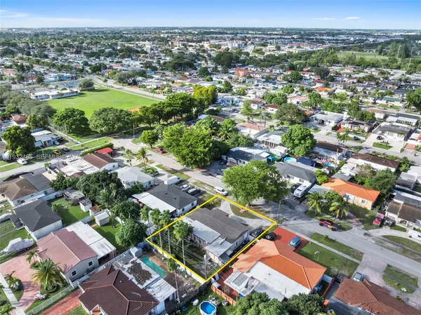 an aerial view of residential houses with outdoor space