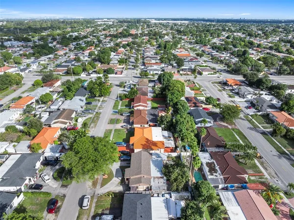 an aerial view of residential houses with outdoor space