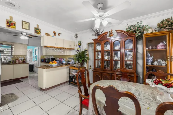 a living room with furniture a chandelier and a dining table