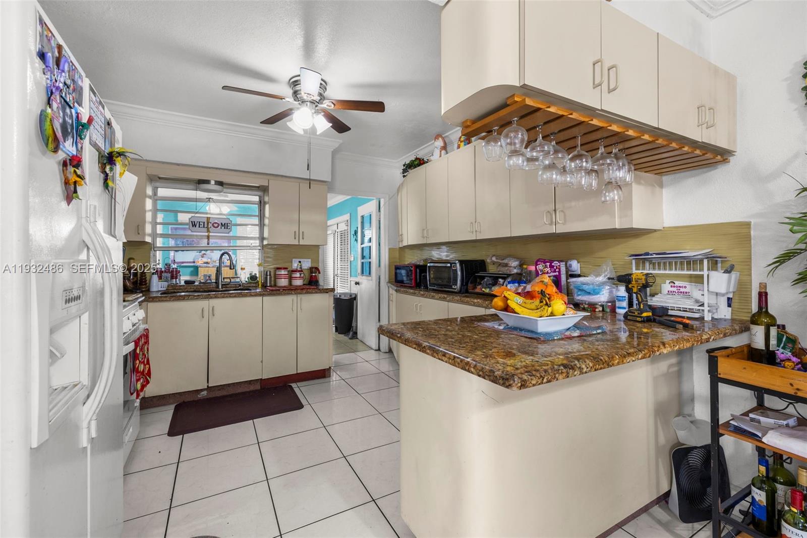 60 West 61st Street Hialeah, FL 33012 - Photo 7 of 43 a kitchen with stainless steel appliances granite countertop a sink a stove and cabinets