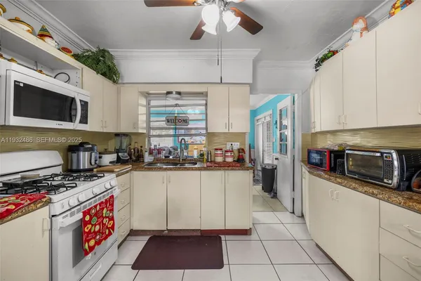 a kitchen with stainless steel appliances a stove a sink cabinets and a counter top space