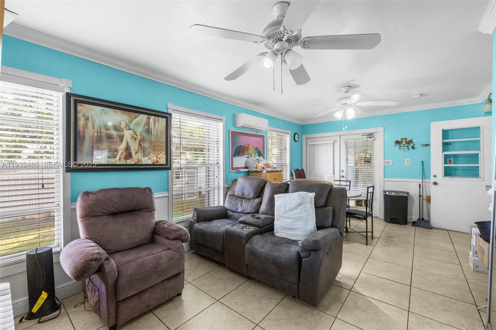60 West 61st Street Hialeah, FL 33012 - Photo 10 of 43 a living room with furniture and a large window