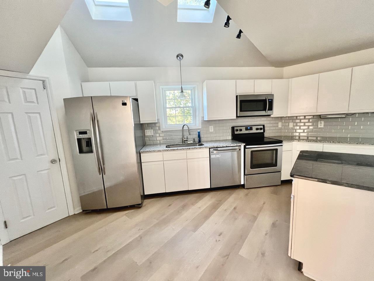 112 Spring Ridge Court Lancaster, PA 17601 - Photo 1 of 19 a kitchen with a sink a refrigerator a microwave and cabinets