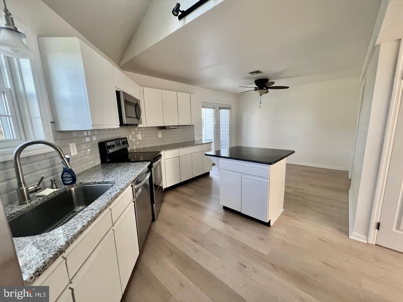 112 Spring Ridge Court Lancaster, PA 17601 - Photo 3 of 19 a kitchen with stainless steel appliances granite countertop a sink a stove and a refrigerator