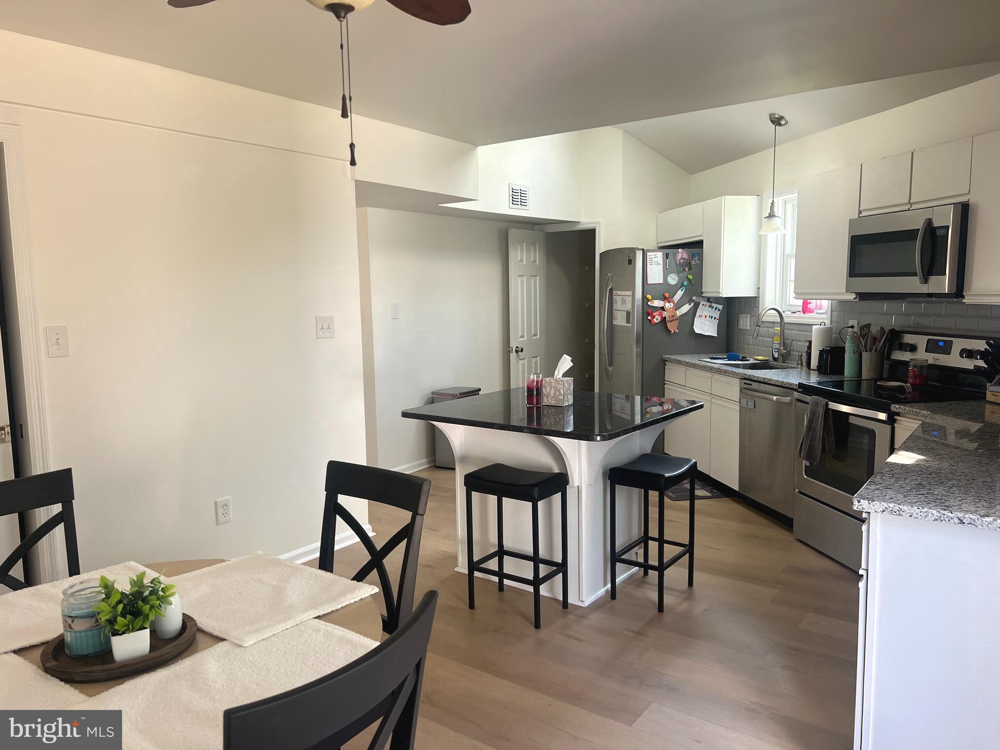 112 Spring Ridge Court Lancaster, PA 17601 - Photo 5 of 19 a kitchen with stainless steel appliances a dining table chairs stove refrigerator and cabinets