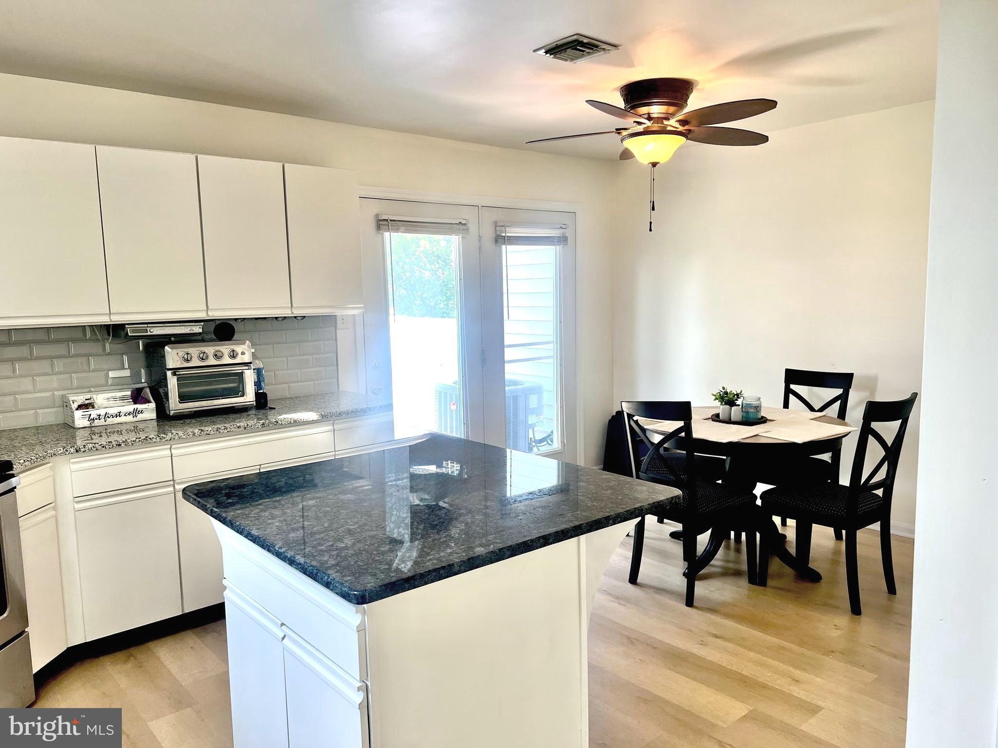 112 Spring Ridge Court Lancaster, PA 17601 - Photo 7 of 19 a kitchen with a dining table and chairs