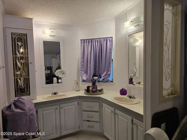 a bathroom with a sink vanity and mirror