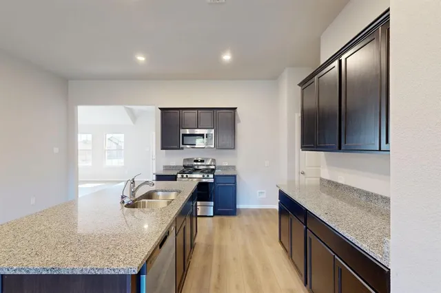 an empty room with wooden floor and window