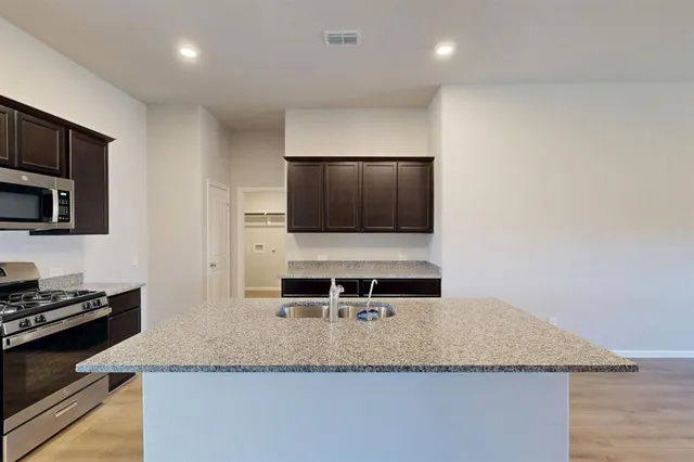 a kitchen with a stove and a microwave