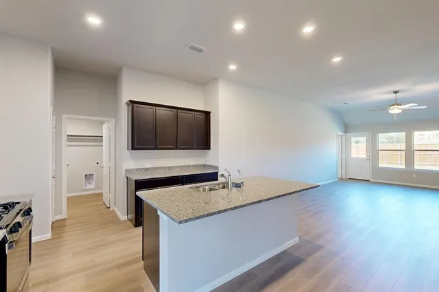 a kitchen with a sink and stainless steel appliances