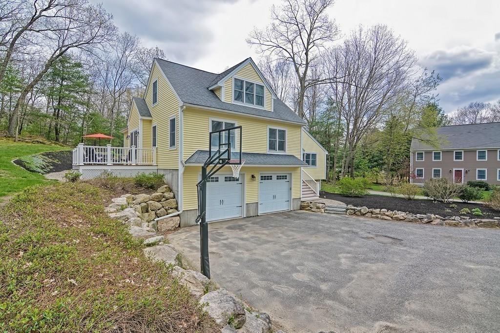 18 Massasoit Path Wayland, MA 01778 - Photo 29 of 39 a view of a house with a large tree and a yard