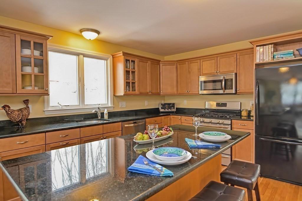18 Massasoit Path Wayland, MA 01778 - Photo 3 of 39 a kitchen with stainless steel appliances granite countertop a stove a sink dishwasher and cabinets with wooden floor