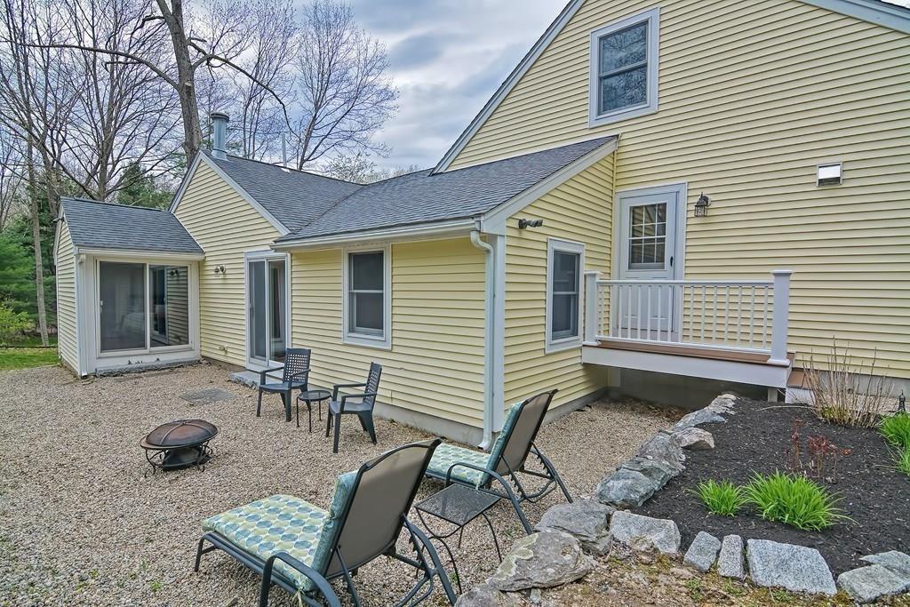 18 Massasoit Path Wayland, MA 01778 - Photo 32 of 39 a backyard of a house with outdoor seating
