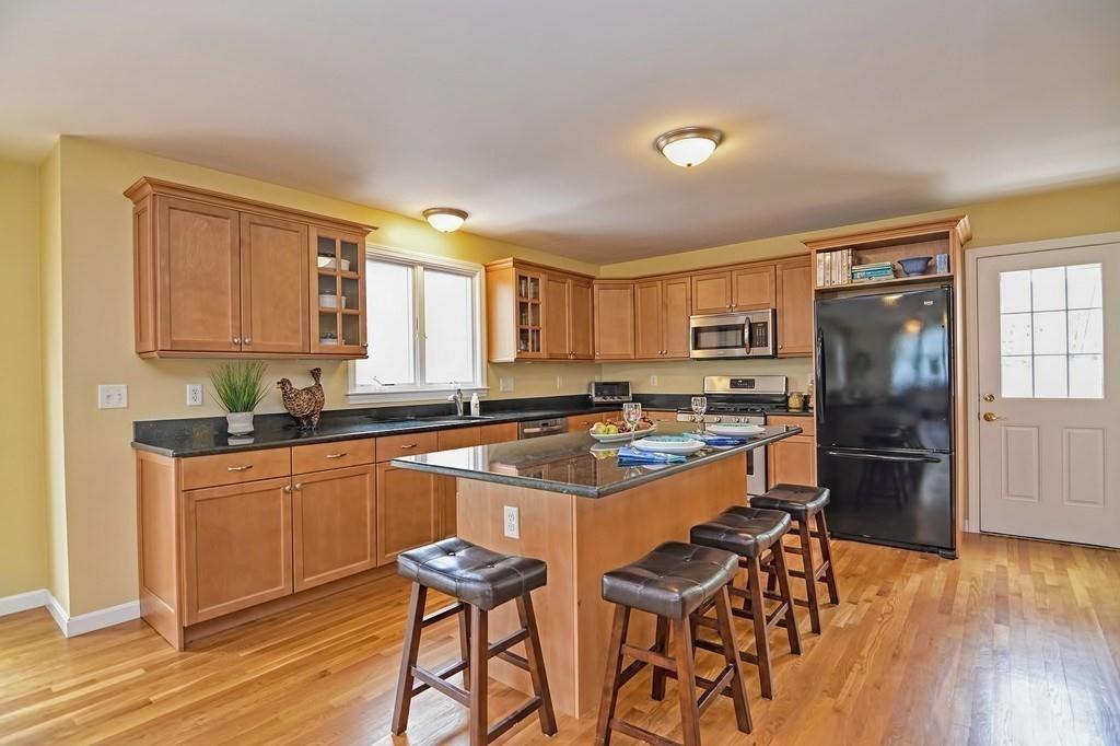 18 Massasoit Path Wayland, MA 01778 - Photo 7 of 39 a kitchen with stainless steel appliances granite countertop a stove and a refrigerator
