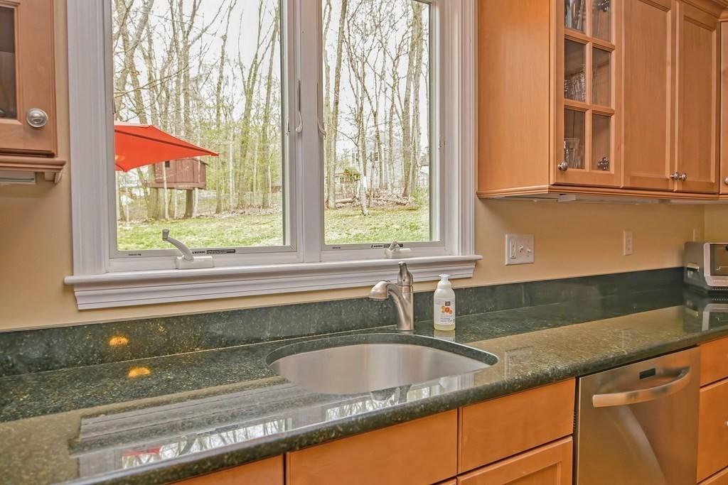 18 Massasoit Path Wayland, MA 01778 - Photo 8 of 39 a kitchen with granite countertop a sink and a large window
