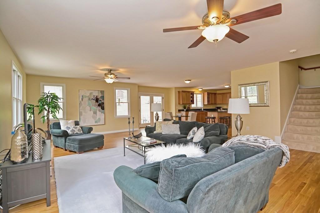 18 Massasoit Path Wayland, MA 01778 - Photo 10 of 39 a living room with furniture kitchen view and a chandelier
