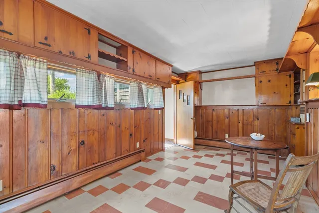 a kitchen with stainless steel appliances granite countertop a sink a stove a refrigerator a washer dryer and white cabinets