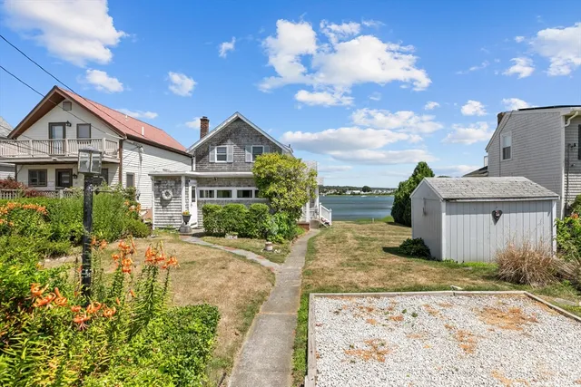 a backyard of a house with table and chairs