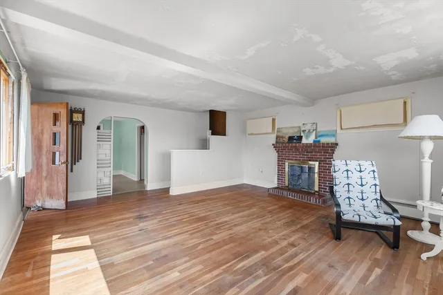 a bedroom with furniture and a wooden floor