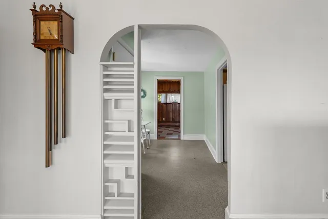 a view of a hallway with wooden floor and entryway