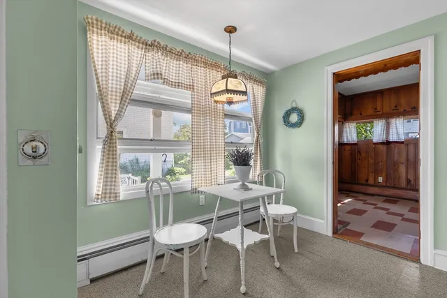 a dining room with furniture and window