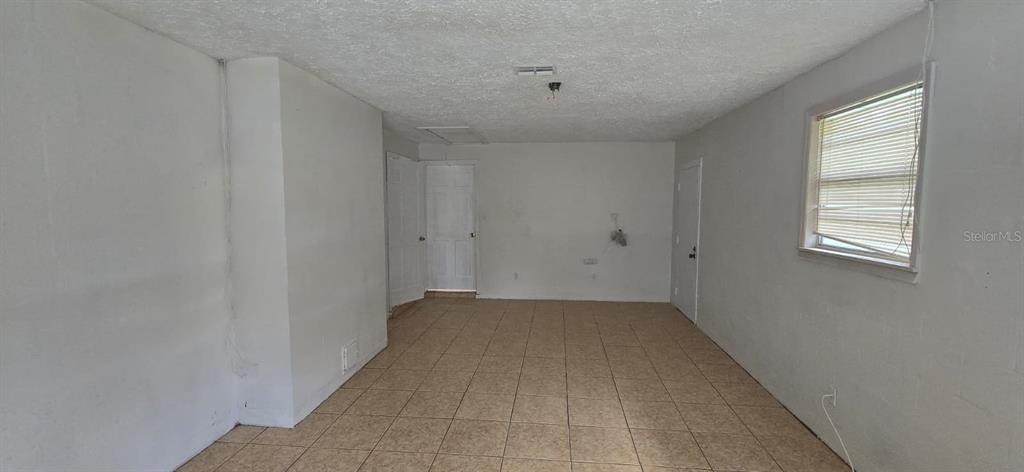 9060 Alan Boulevard Punta Gorda, FL 33982 - Photo 14 of 20 wooden floor in an empty room with a window