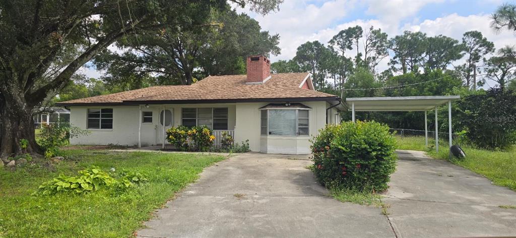 9060 Alan Boulevard Punta Gorda, FL 33982 - Photo 20 of 20 a front view of a house with a garden