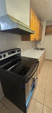 a stove top oven sitting inside of a kitchen