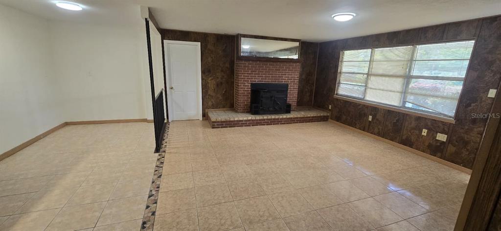 9060 Alan Boulevard Punta Gorda, FL 33982 - Photo 10 of 20 an empty room with windows and fireplace