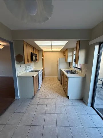 a kitchen with stainless steel appliances a stove a sink and a refrigerator