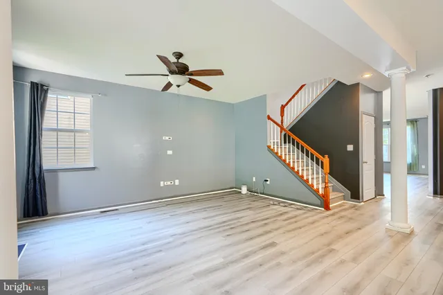 a view of an empty room with a fireplace and a window
