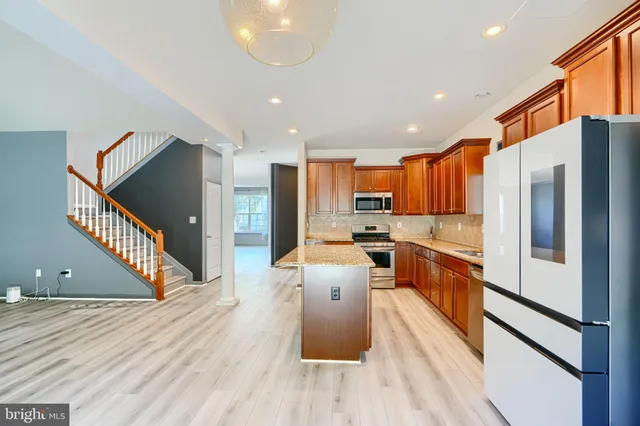 a kitchen with stainless steel appliances granite countertop a sink and cabinets