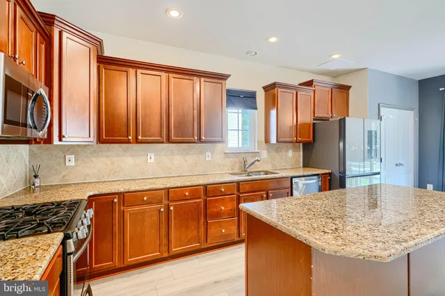 a view of a kitchen with a sink and a refrigerator