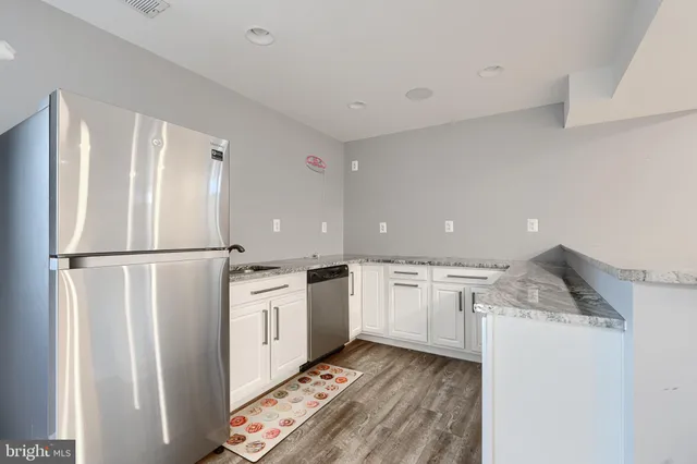 a bathroom with a sink toilet a mirror and shower