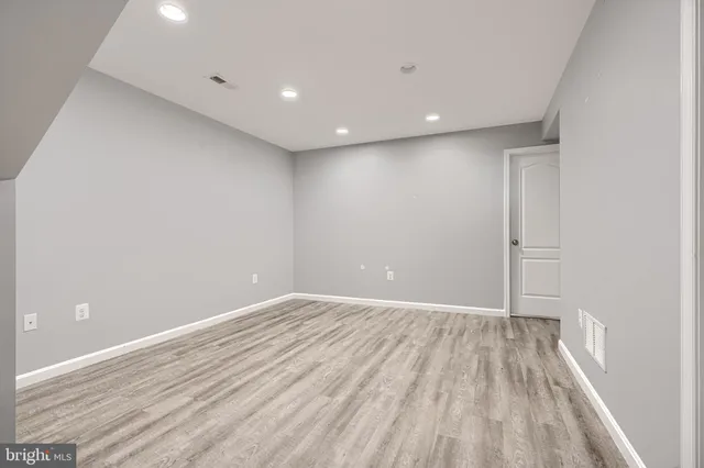 a view of an empty room with a fireplace