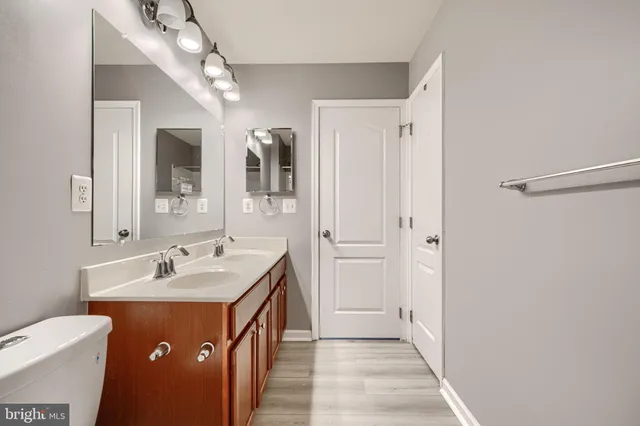 a bathroom with a shower sink and mirror