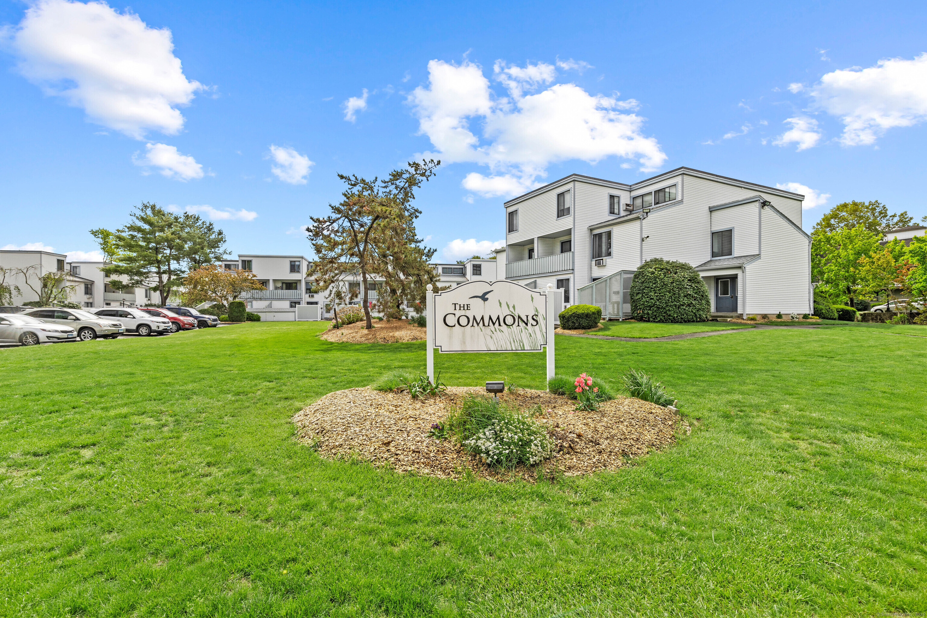 18 Hamre Lane, Unit B Branford, CT 06405 - Photo 1 of 1 a view of a white house with a big yard and potted plants