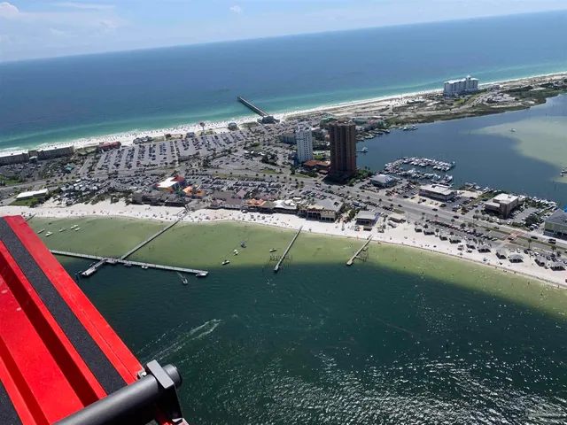 an aerial view of a house with a mountain