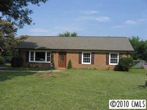 7416 Cormwell Lane Charlotte, NC 28217 - Photo 1 of 8 a front view of a house with a garden