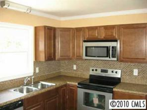 7416 Cormwell Lane Charlotte, NC 28217 - Photo 2 of 8 a kitchen with a sink stove and microwave