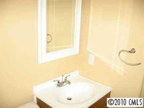 7416 Cormwell Lane Charlotte, NC 28217 - Photo 5 of 8 a bathroom with a sink and a mirror